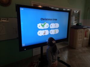 Zdjęcie dzieci rozwiązujących zadania z języka angielskiego przy monitorze