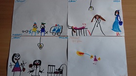 Prace plastyczne dzieci narysowane flamastrami, leżące na stole. Przedstawiające strażaka, lekarza oraz policjanta.