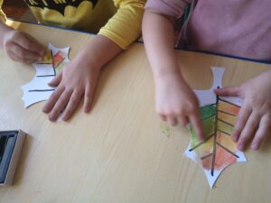 dzieci kolorują pastelami liście