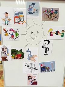 Plakat, na jego środku jest uśmiechnięte słoneczko, wokół którego są obrazki przedstawiajace zdrowe jedzenie i czynności związane z dbaniem o zdrowie.